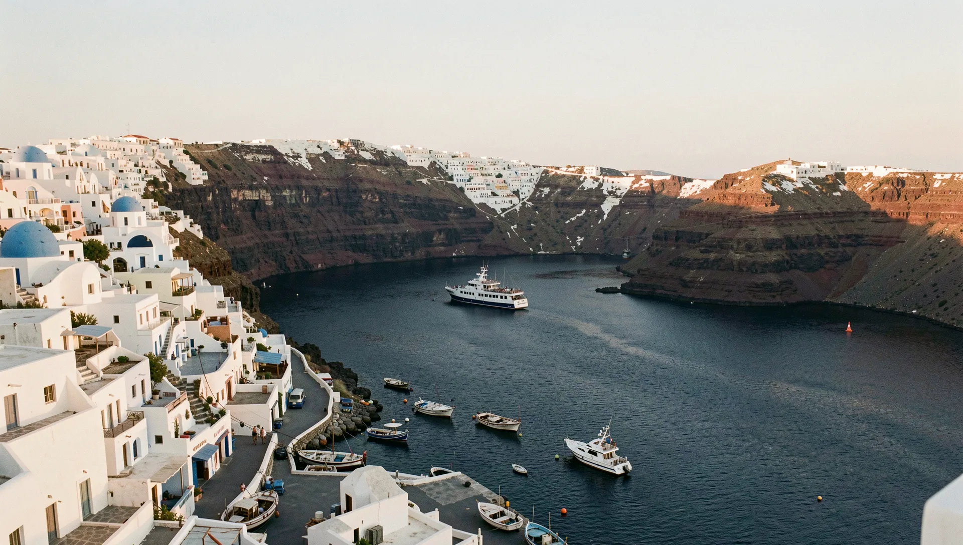 Santorini, Greece, seen from the water at golden hour